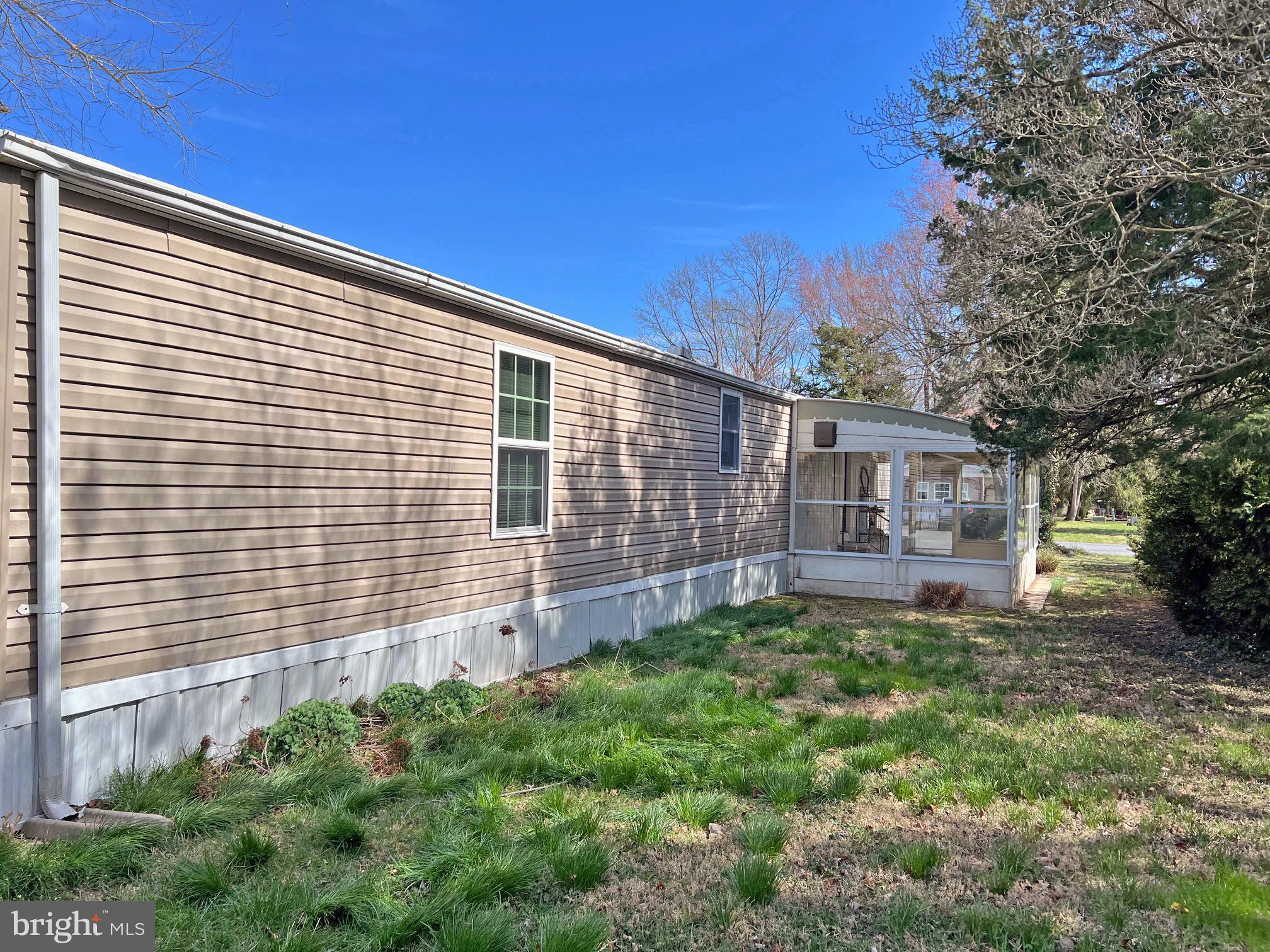 33943 Cedar Road, Unit 87 Lewes, DE 19958 - Photo 23 of 26 Side Yard and 2nd Screened Porch