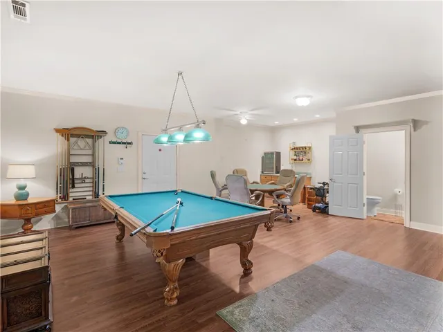 a room with lots of furniture and wooden floor