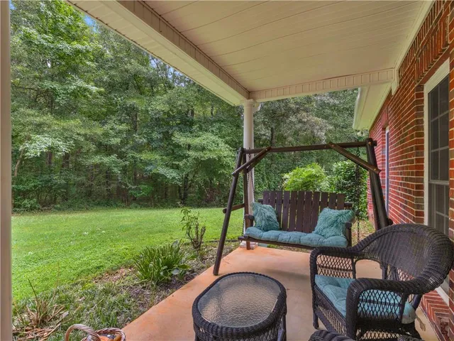 a backyard of a house with table and chairs