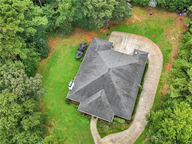 an aerial view of a house with a yard and lake view