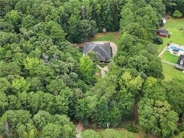an aerial view of a house with a yard and outdoor seating
