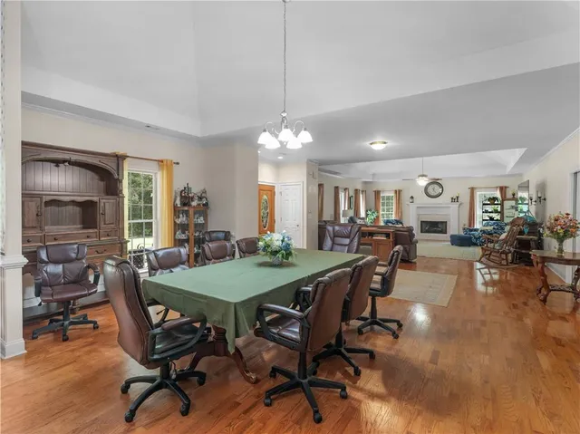 a view of a dining room with furniture and a chandelier