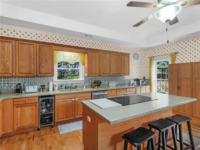 a kitchen with a sink a counter top space stainless steel appliances and cabinets