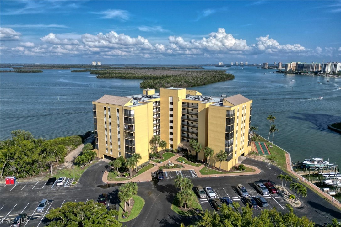 400 Lenell Road, Unit 408 Fort Myers Beach, FL 33931 - Photo 2 of 34 a balcony with outdoor seating and city view