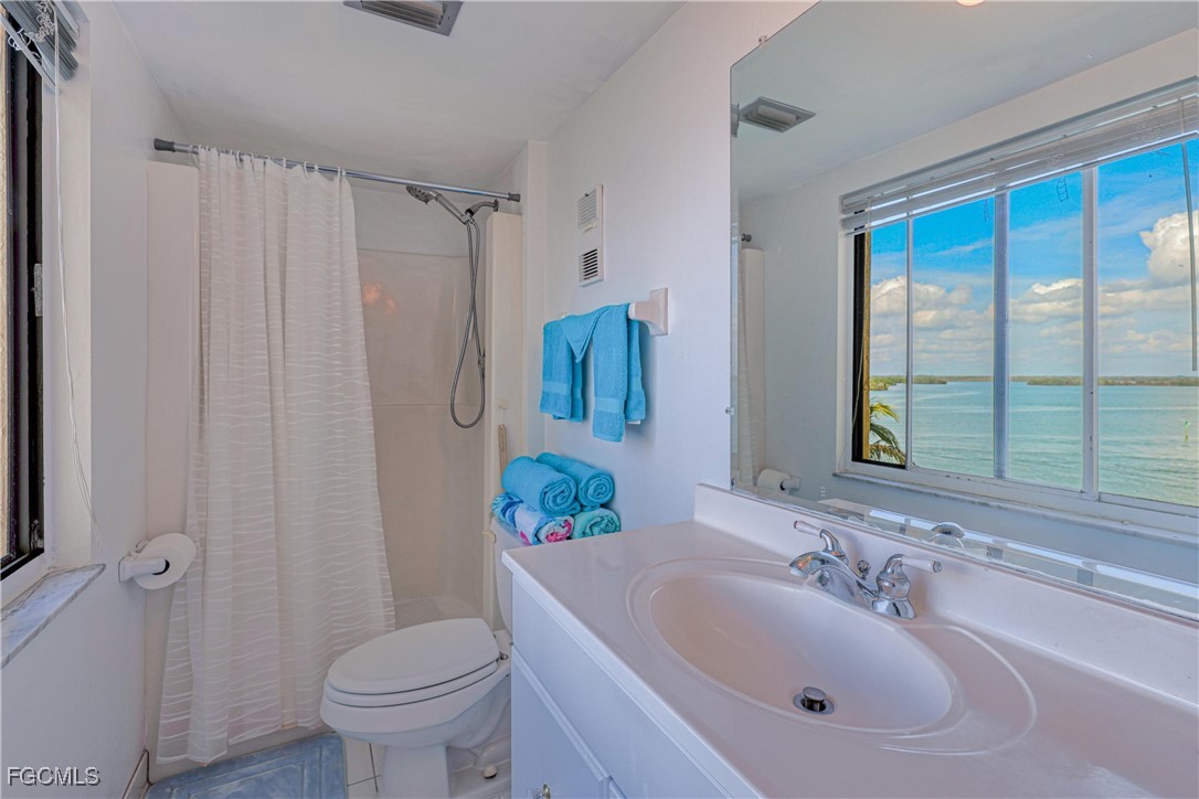 400 Lenell Road, Unit 408 Fort Myers Beach, FL 33931 - Photo 21 of 34 a bathroom with a sink toilet and shower