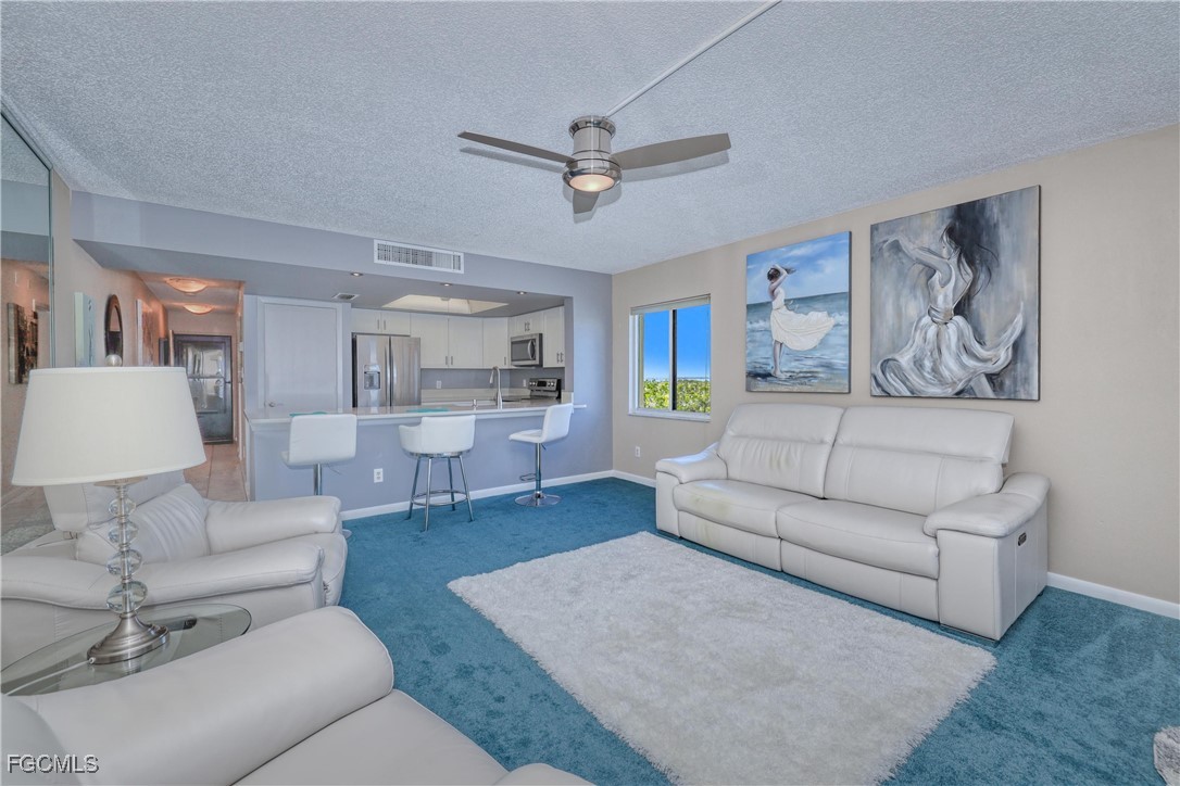 400 Lenell Road, Unit 408 Fort Myers Beach, FL 33931 - Photo 29 of 34 a living room with furniture and a view of kitchen