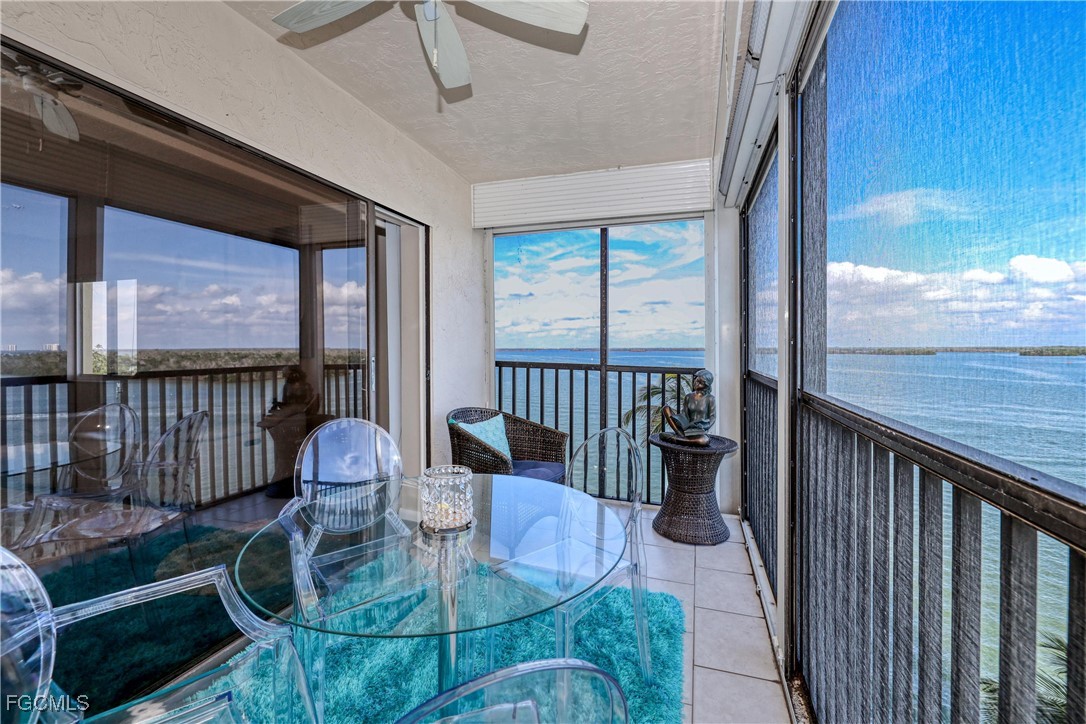 400 Lenell Road, Unit 408 Fort Myers Beach, FL 33931 - Photo 4 of 34 a view of a dining room with furniture wooden floor and chandelier