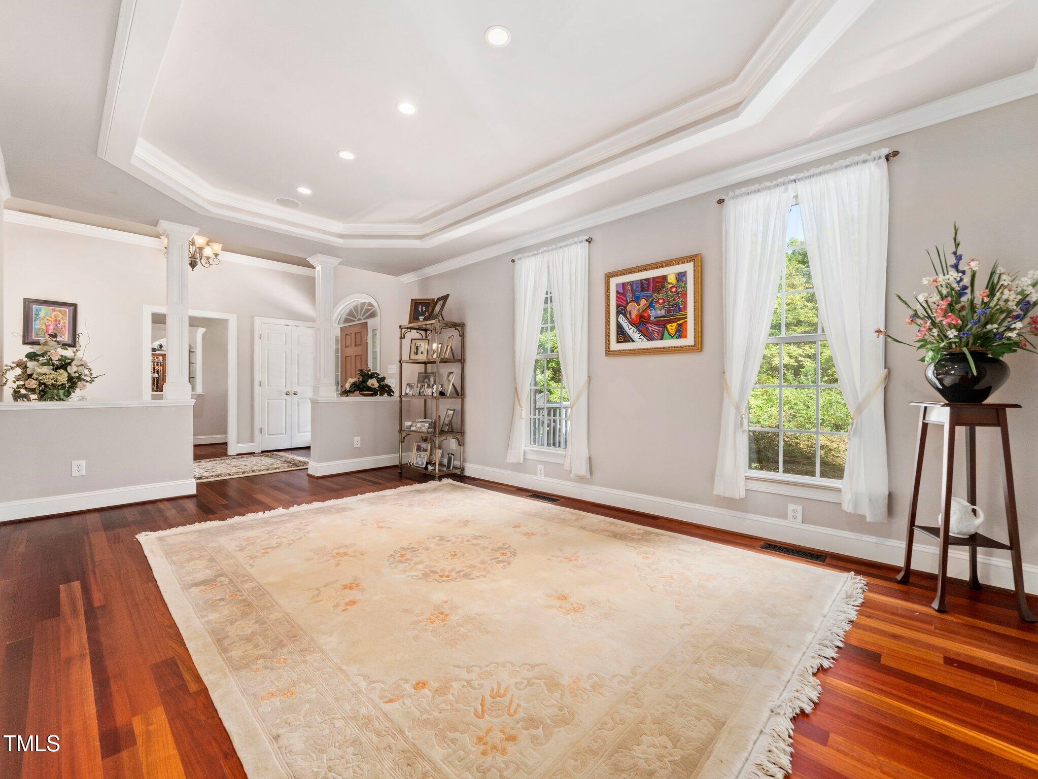 10937 Cahill Road Raleigh, NC 27614 - Photo 25 of 53 a view of an empty room with wooden floor and a window