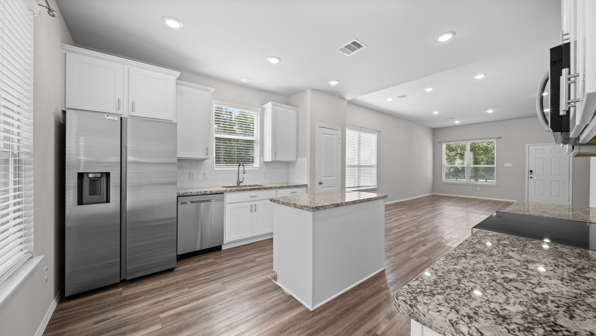18140 Mail Rte Road Montgomery, TX 77316 - Photo 10 of 26 A seamless flow between the kitchen, dining, and family room creates an inviting space for family and guests.