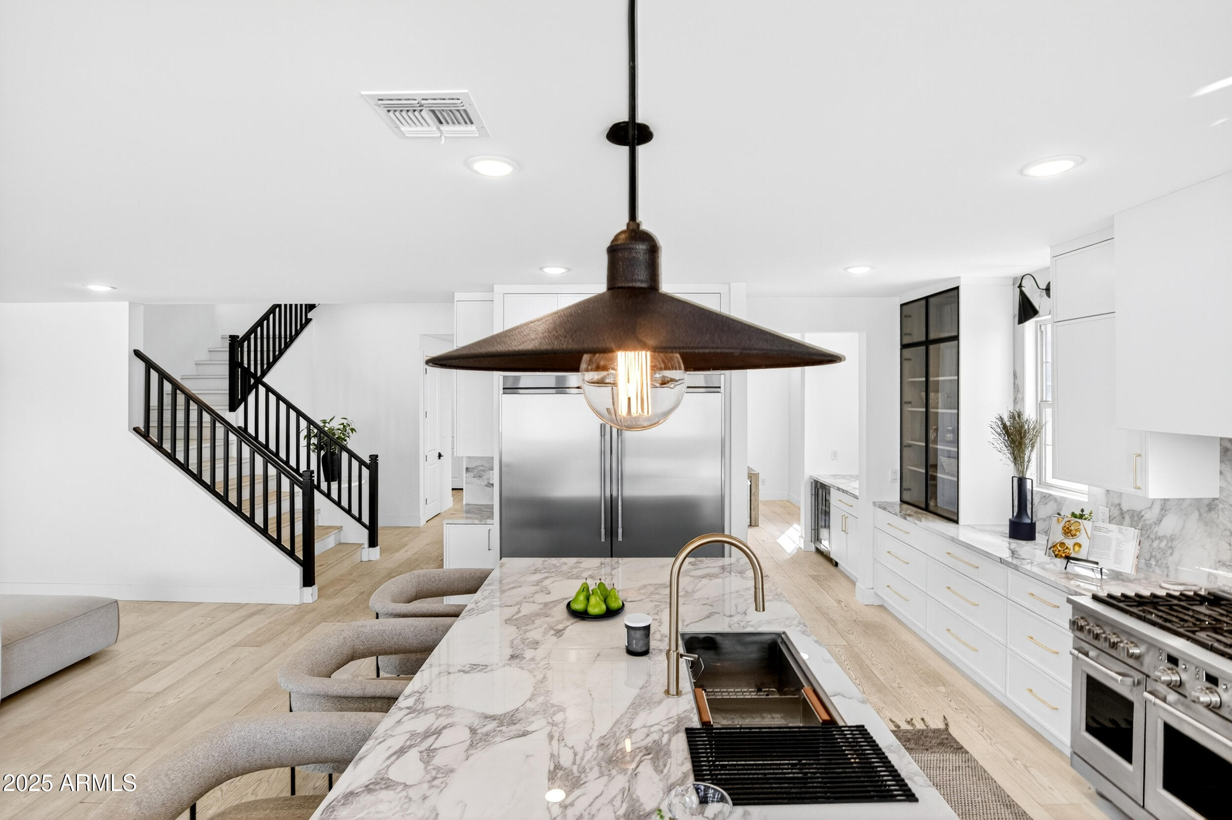 4247 South Element Mesa, AZ 85212 - Photo 27 of 120 a kitchen with stainless steel appliances a stove a sink and a chandelier
