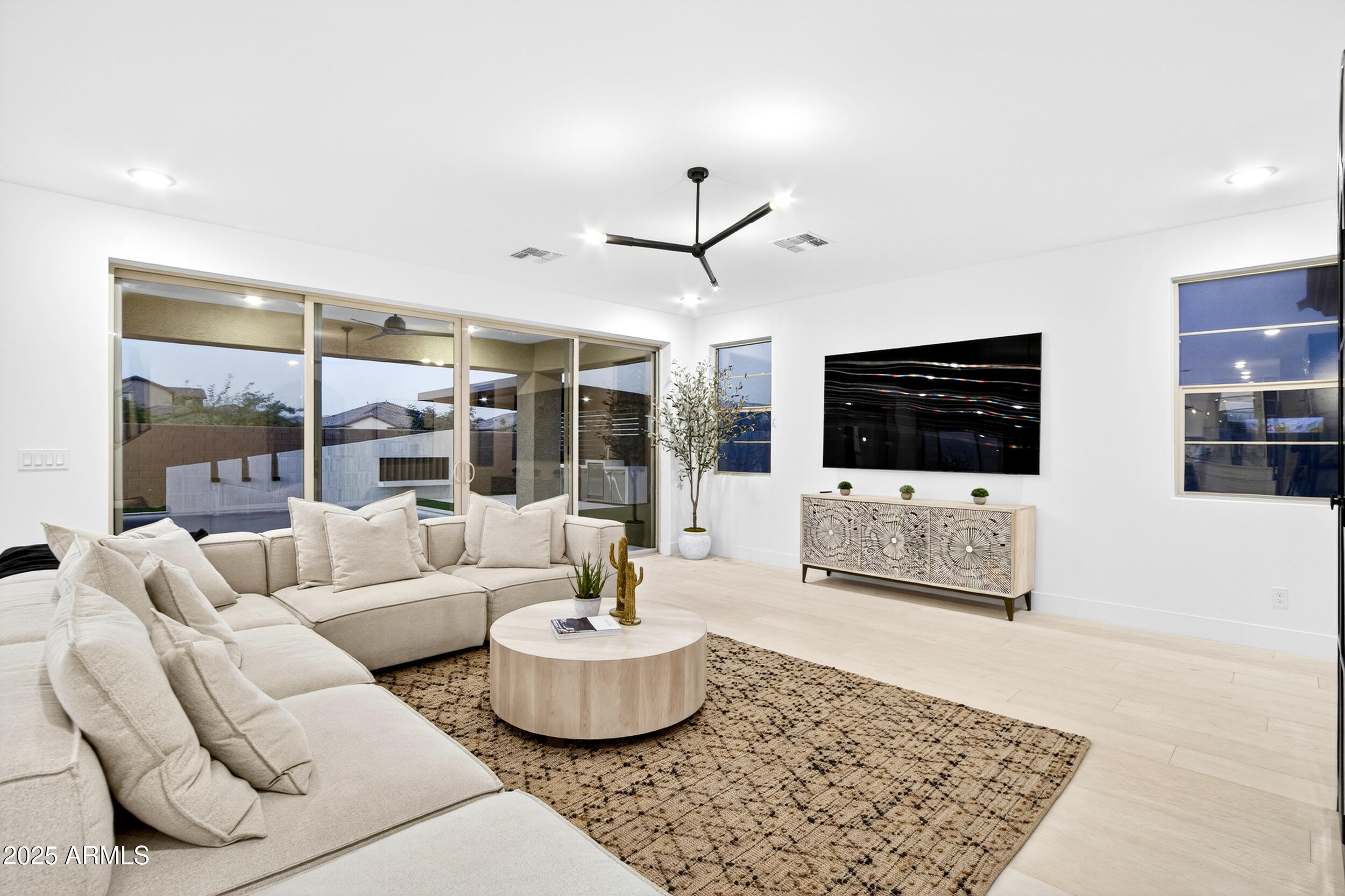 4247 South Element Mesa, AZ 85212 - Photo 45 of 120 a living room with furniture potted plant and a flat screen tv