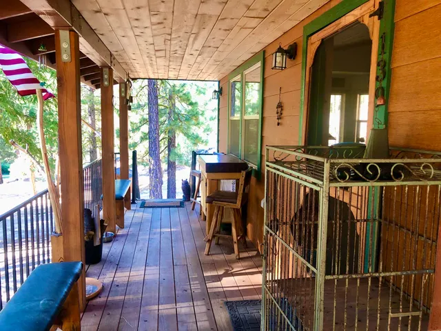 a view of backyard with a barn and large trees