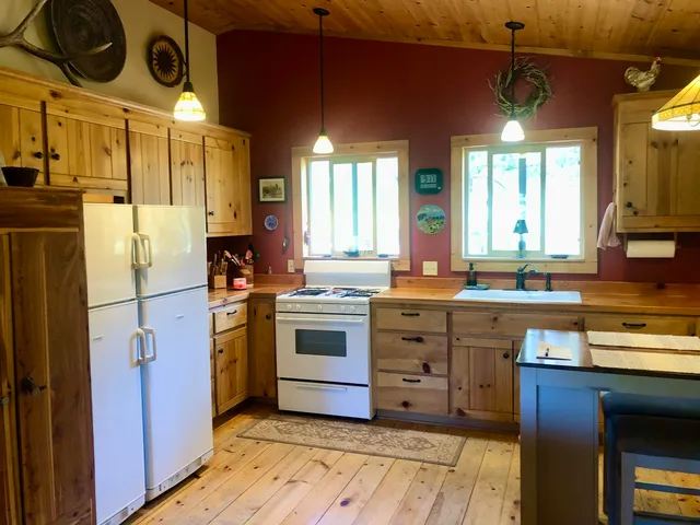 a kitchen with a stove kitchen island and stainless steel appliances