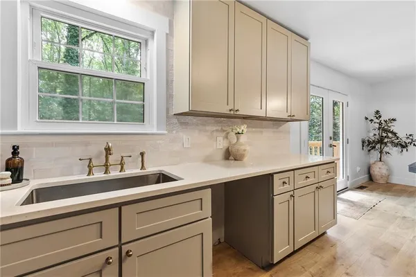 a kitchen with stainless steel appliances granite countertop a sink a stove and cabinets