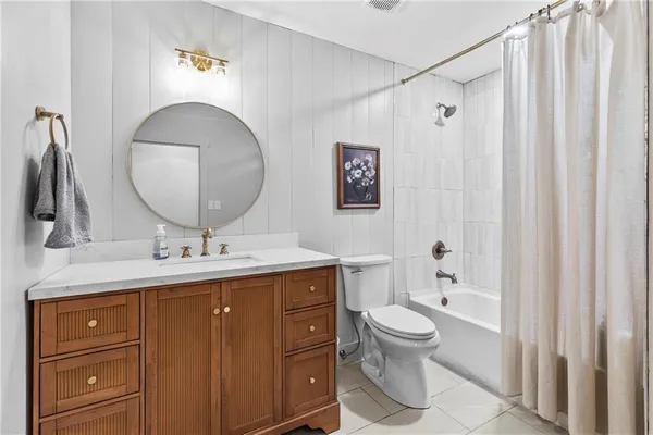 a bathroom with a toilet sink double vanity and mirror