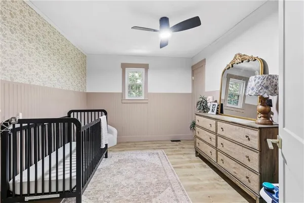 a bedroom with a bed and a dresser in it