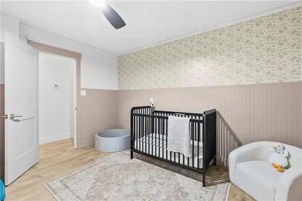 a living room with a baby crib furniture and a window