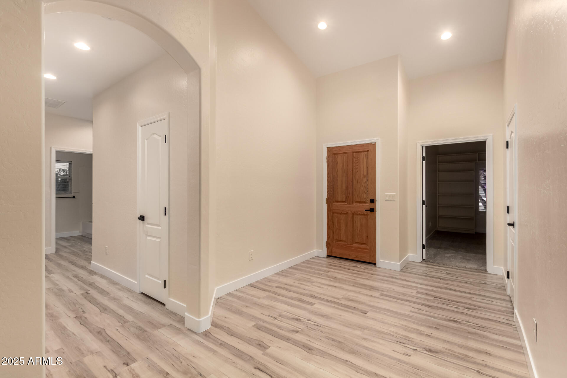 4273 South 165th Way Gilbert, AZ 85297 - Photo 9 of 56 a view of a hallway with wooden floor and closet