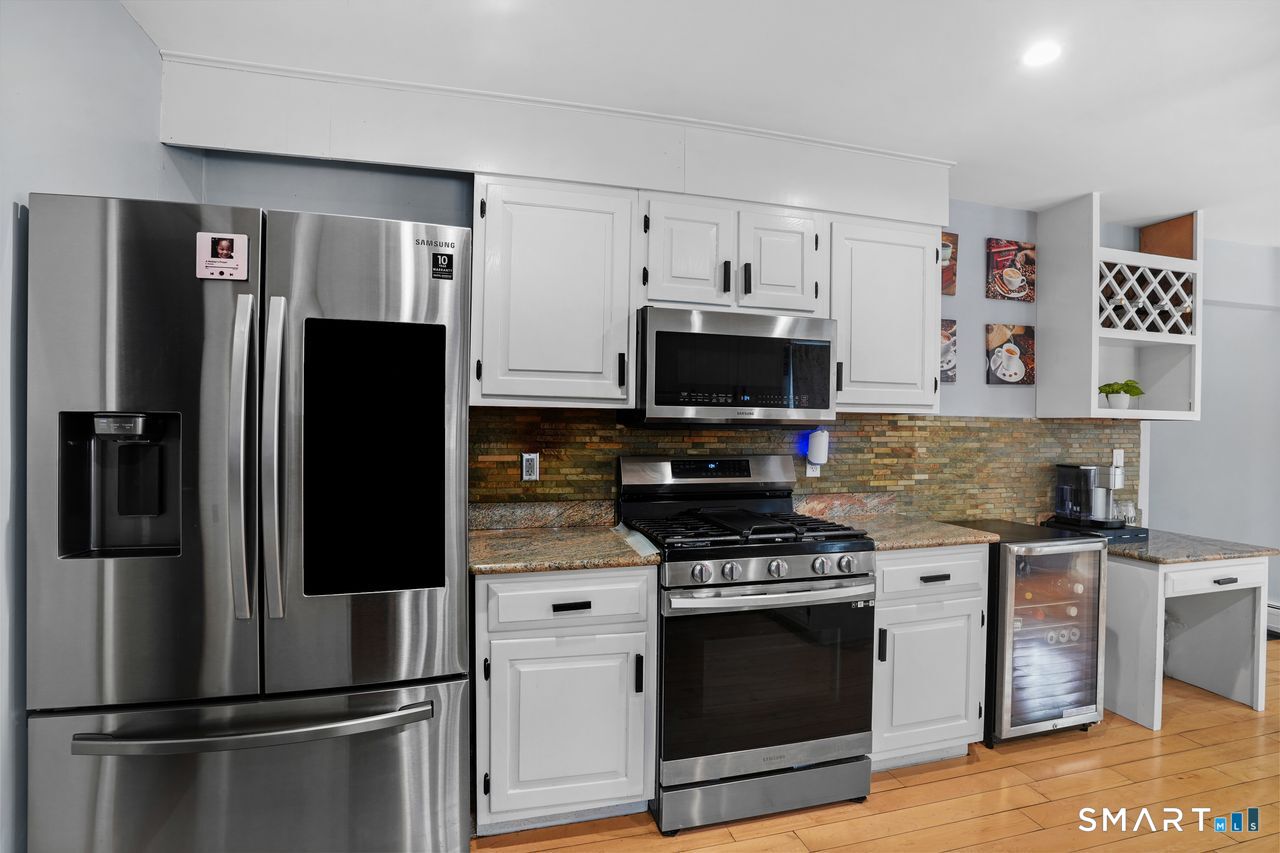 17 Moose Hill Road Trumbull, CT 06611 - Photo 12 of 40 a kitchen with stainless steel appliances a refrigerator stove and microwave
