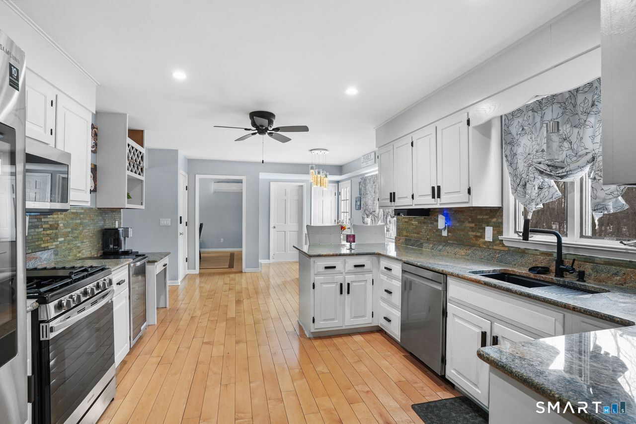 17 Moose Hill Road Trumbull, CT 06611 - Photo 13 of 40 a large kitchen with stainless steel appliances granite countertop a lot of counter space and wooden floors