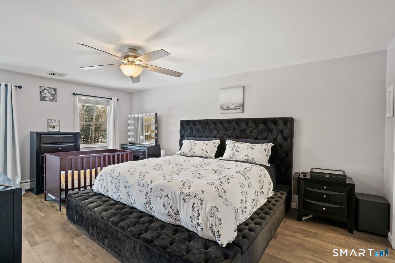 17 Moose Hill Road Trumbull, CT 06611 - Photo 21 of 40 a bedroom with a bed and wooden floor