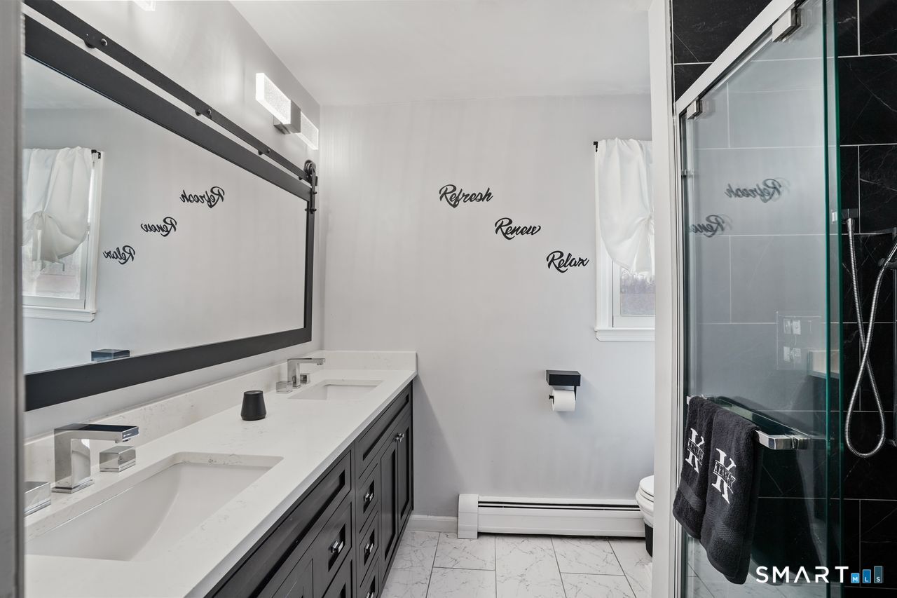 17 Moose Hill Road Trumbull, CT 06611 - Photo 24 of 40 a bathroom with a sink and mirror