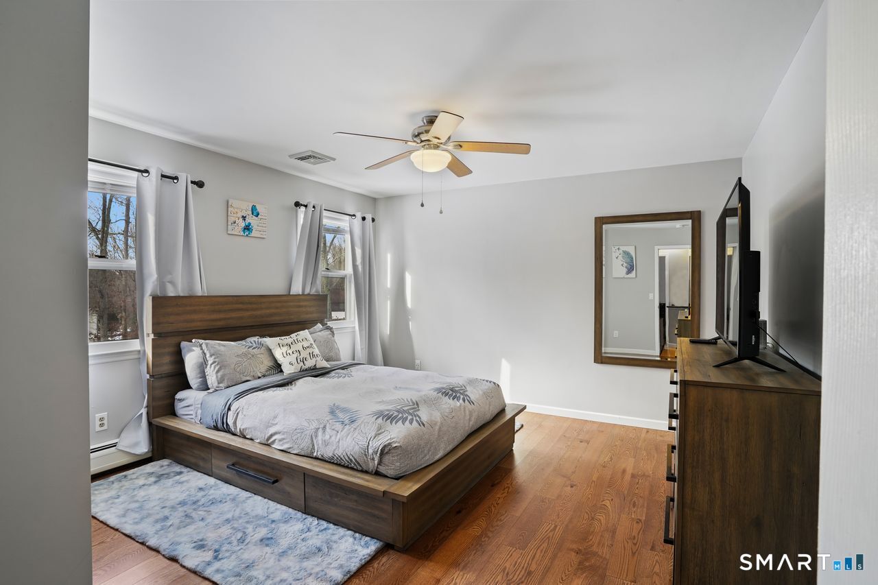 17 Moose Hill Road Trumbull, CT 06611 - Photo 25 of 40 a bedroom with a bed and a chandelier