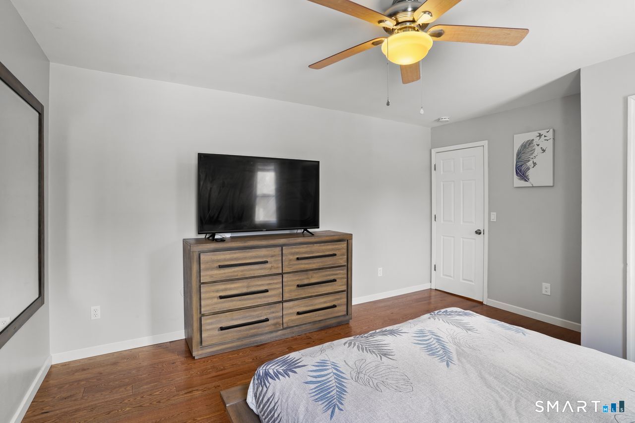 17 Moose Hill Road Trumbull, CT 06611 - Photo 27 of 40 a bedroom with a bed and a flat screen tv