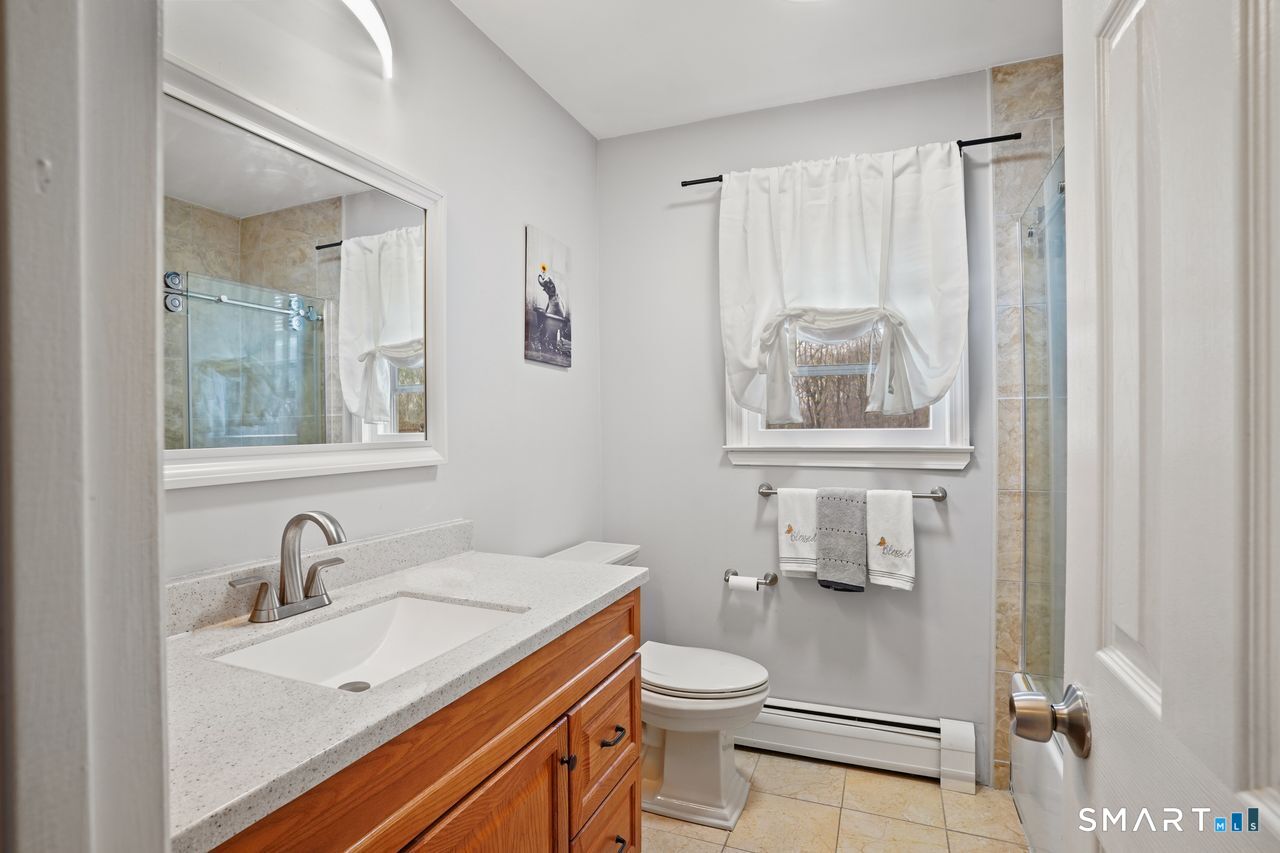17 Moose Hill Road Trumbull, CT 06611 - Photo 28 of 40 a bathroom with a sink a toilet and a mirror