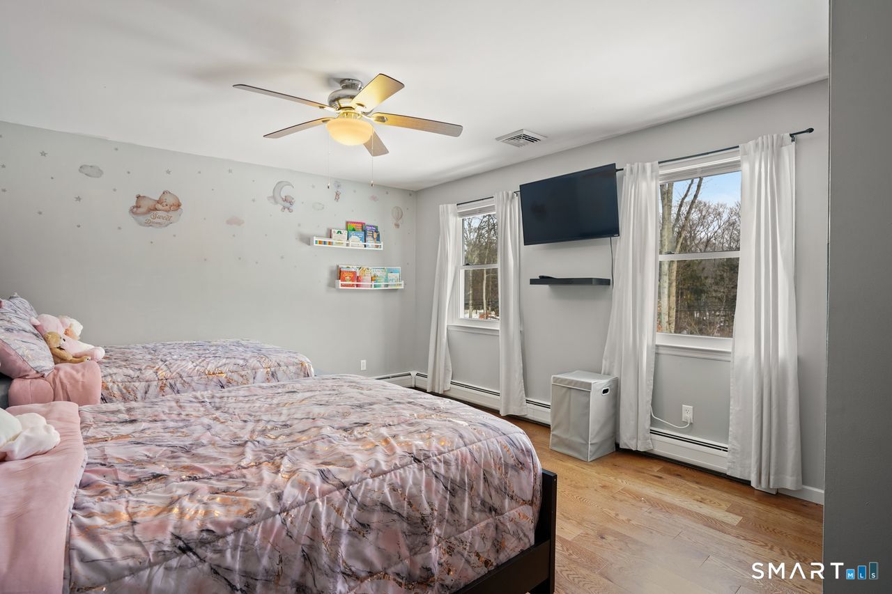 17 Moose Hill Road Trumbull, CT 06611 - Photo 29 of 40 a bedroom with a large bed and a flat tv screen