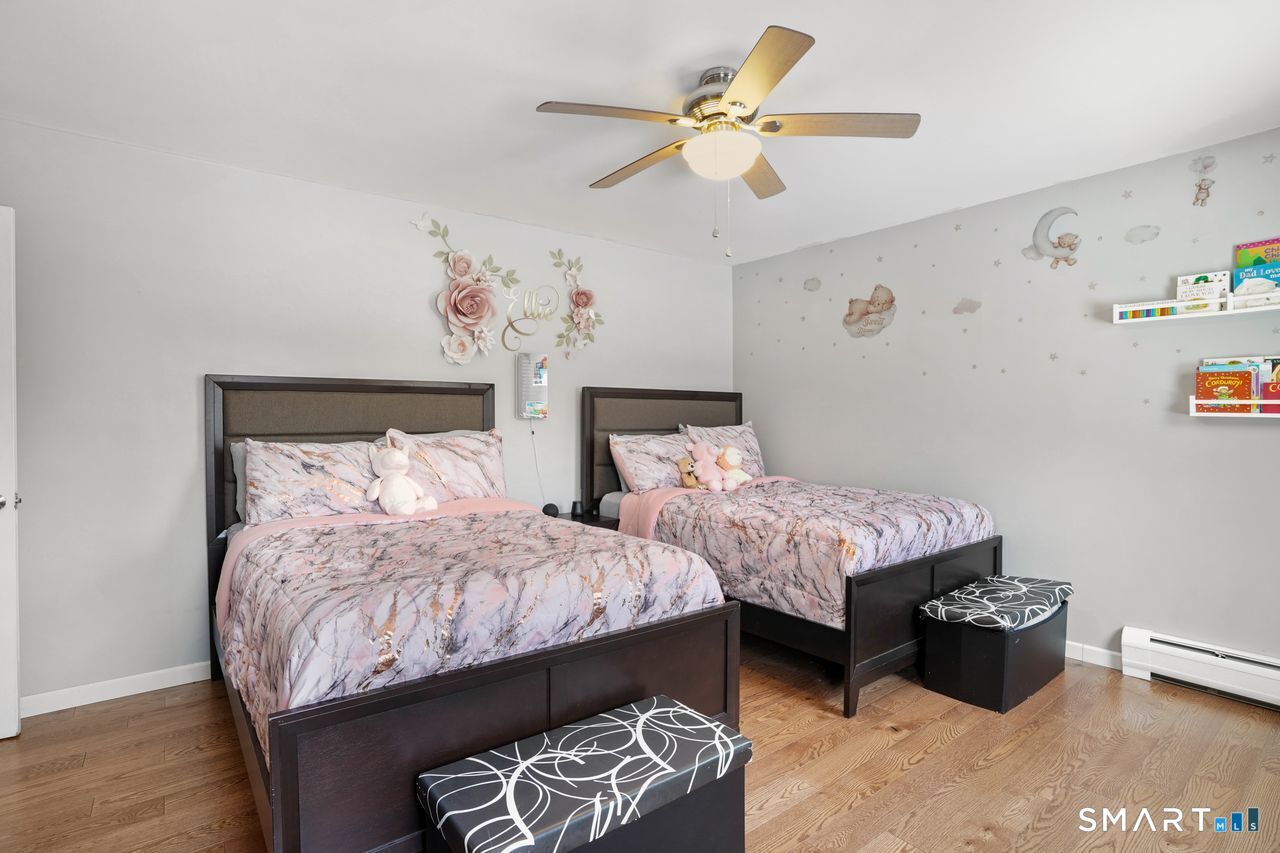 17 Moose Hill Road Trumbull, CT 06611 - Photo 30 of 40 a bedroom with two beds and ceiling fan