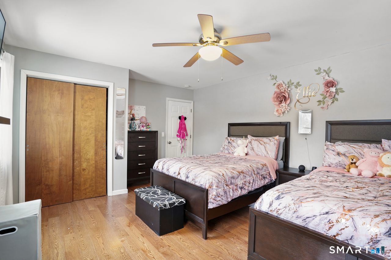 17 Moose Hill Road Trumbull, CT 06611 - Photo 31 of 40 a bedroom with two beds and a chandelier