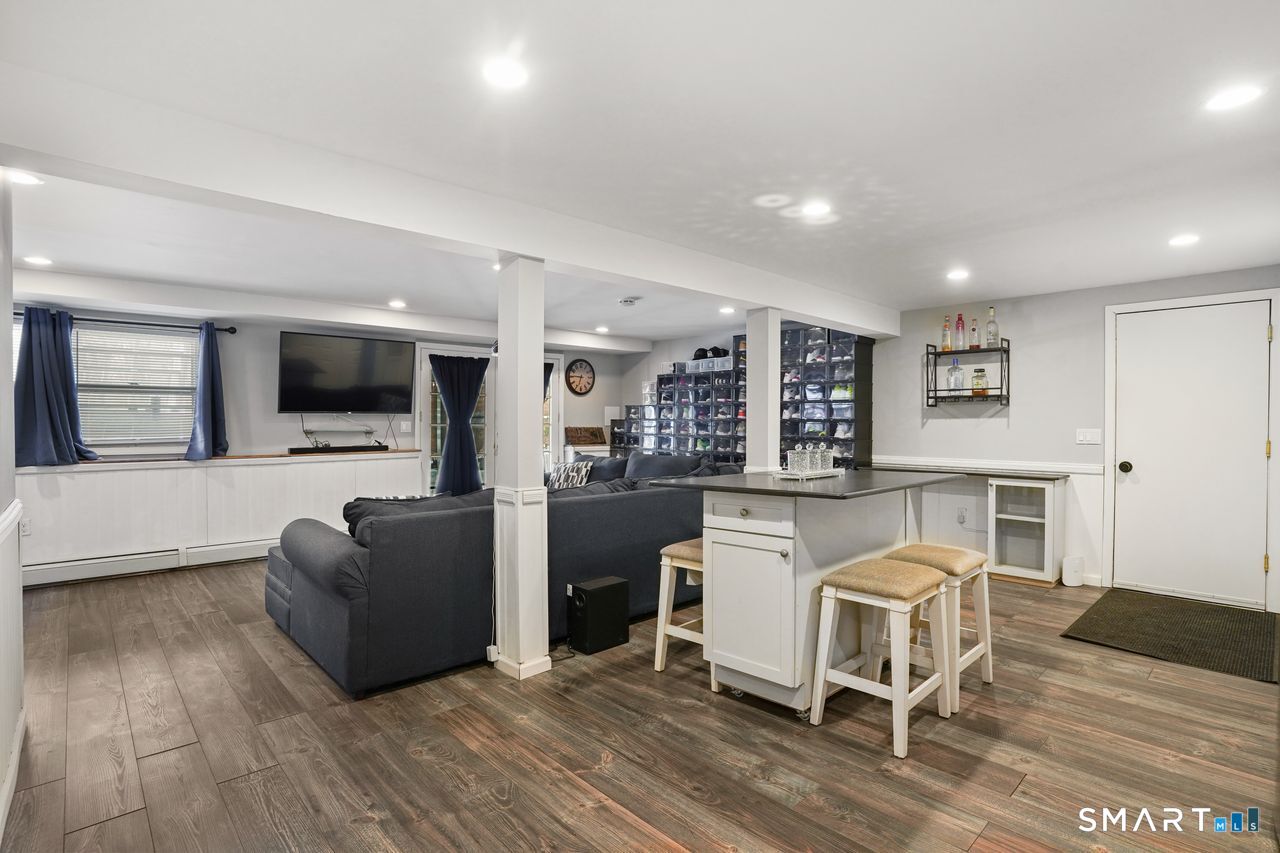 17 Moose Hill Road Trumbull, CT 06611 - Photo 34 of 40 a living room with furniture a flat screen tv and kitchen view