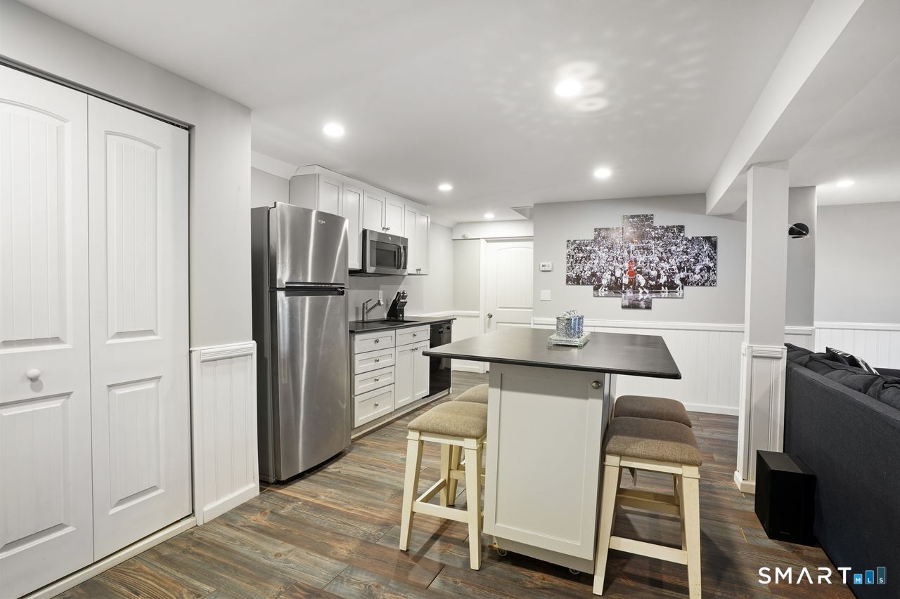 17 Moose Hill Road Trumbull, CT 06611 - Photo 36 of 40 a kitchen with stainless steel appliances kitchen island granite countertop a refrigerator and a stove top oven