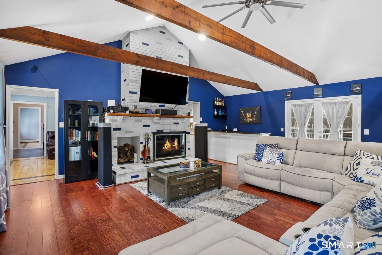 17 Moose Hill Road Trumbull, CT 06611 - Photo 6 of 40 a living room with furniture and a flat screen tv