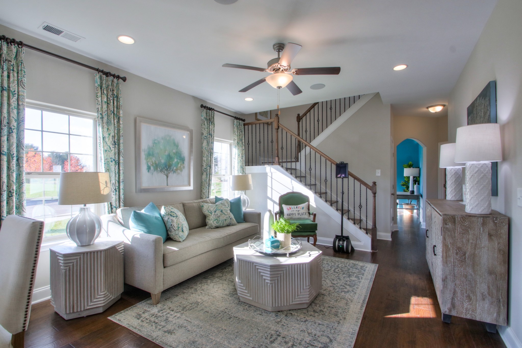 a living room with furniture and a potted plant