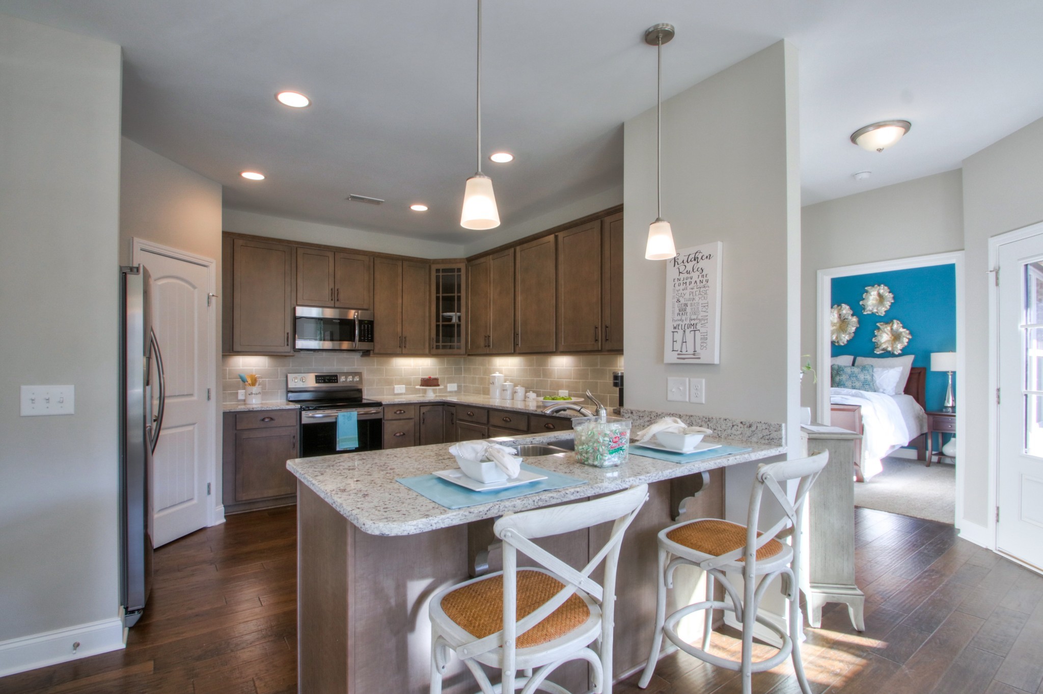 223 Cloverbrook Way Gallatin, TN 37066 - Photo 13 of 51 a kitchen with a dining table chairs refrigerator and microwave