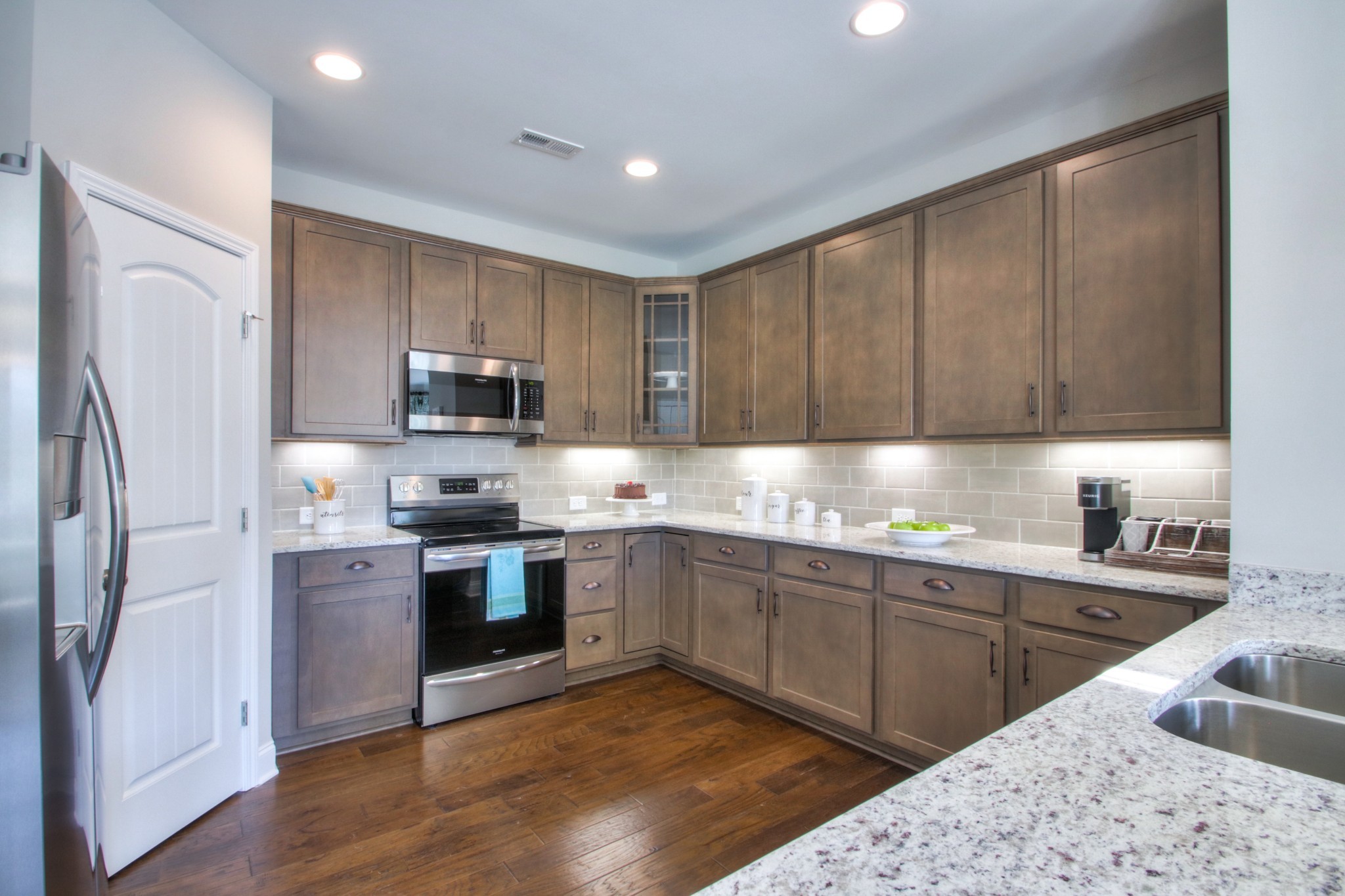 223 Cloverbrook Way Gallatin, TN 37066 - Photo 14 of 51 a kitchen with stainless steel appliances granite countertop a sink stove and refrigerator
