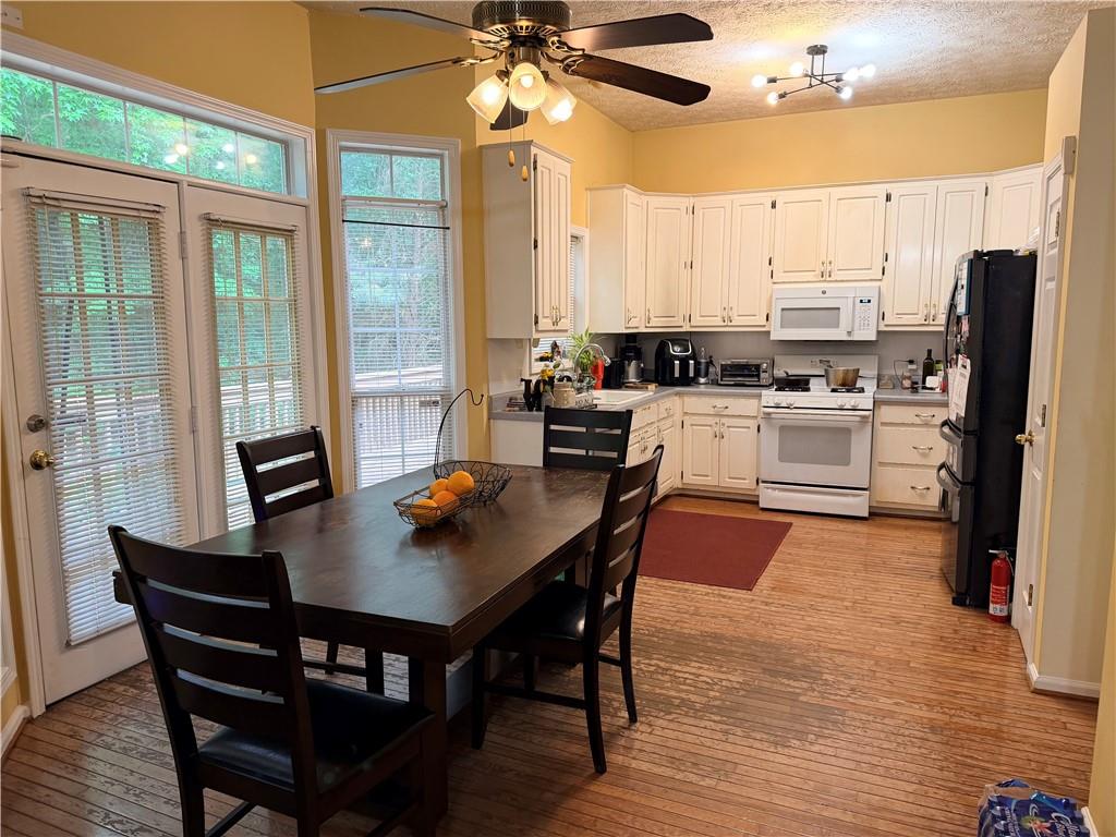 426 Pates Lake Court Hampton, GA 30228 - Photo 44 of 60 a kitchen with a dining table chairs and refrigerator