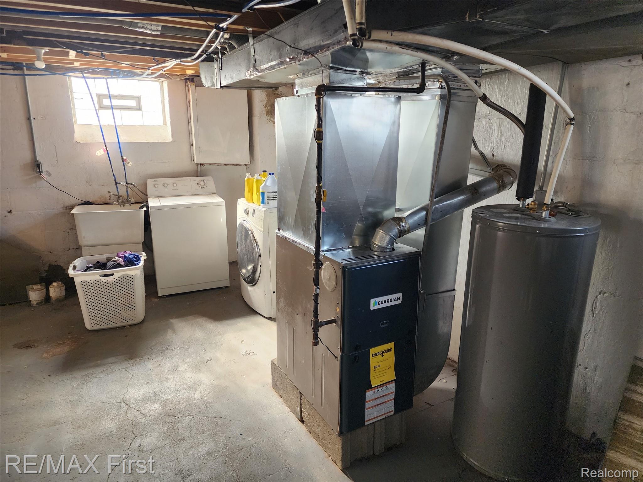 19345 Keystone Street Detroit, MI 48234 - Photo 12 of 15 Below grade area featuring heating unit, electric water heater, and washing machine and clothes dryer