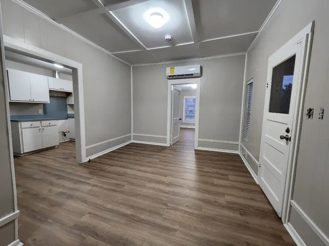 a view of hallway with wooden floor