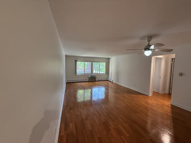 677 South River Road, Unit 2A Des Plaines, IL 60016 - Photo 4 of 15 a view of empty room with wooden floor and fan
