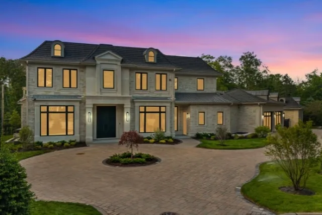 a front view of a house with yard and green space