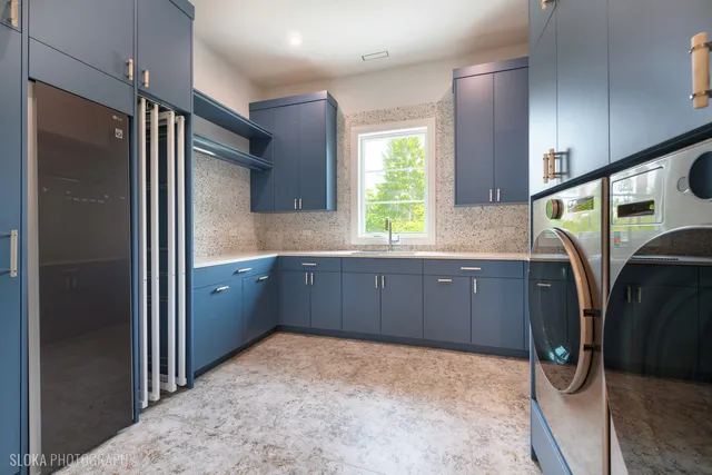 a large kitchen with stainless steel appliances granite countertop a stove and refrigerator