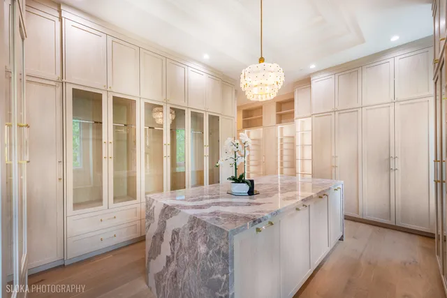 a bathroom with a granite countertop sink and a large mirror
