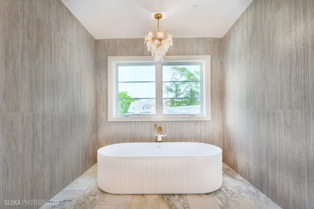 a view of a room with a ceiling fan and entryway
