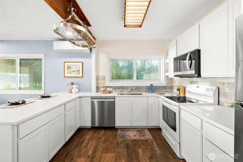 a kitchen with a sink stove and cabinets