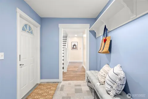 a view of a hallway with bed and furniture