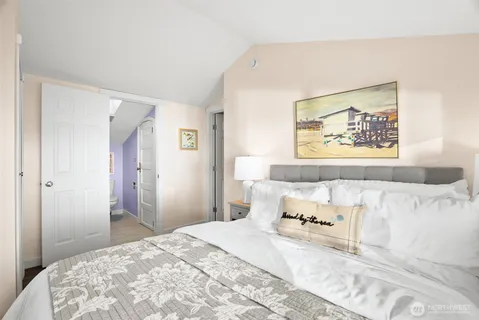 a bedroom with furniture and a large window