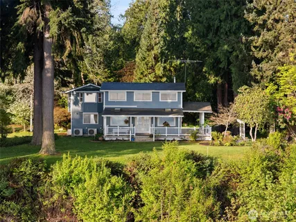 a view of a house with a yard and garage